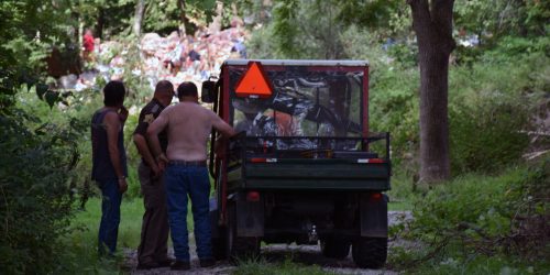 Neighbors and officers watch as the crew works to find the victims of the house explosion. (Photo by Maggie Kenworthy)