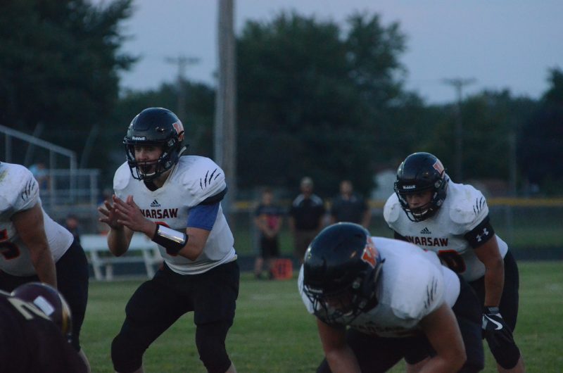 Michael Jensen prepares to take a snap for Warsaw Friday night. Jensen ran for a touchdown in a 30-7 season-opening win at Columbia City.