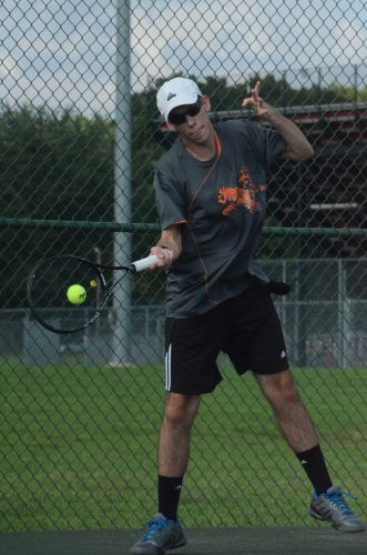 Ryan Wettschurack hits a shot in No. 1 doubles play for Warsaw during a 5-0 win at Elkhart Memorial Thursday evening.