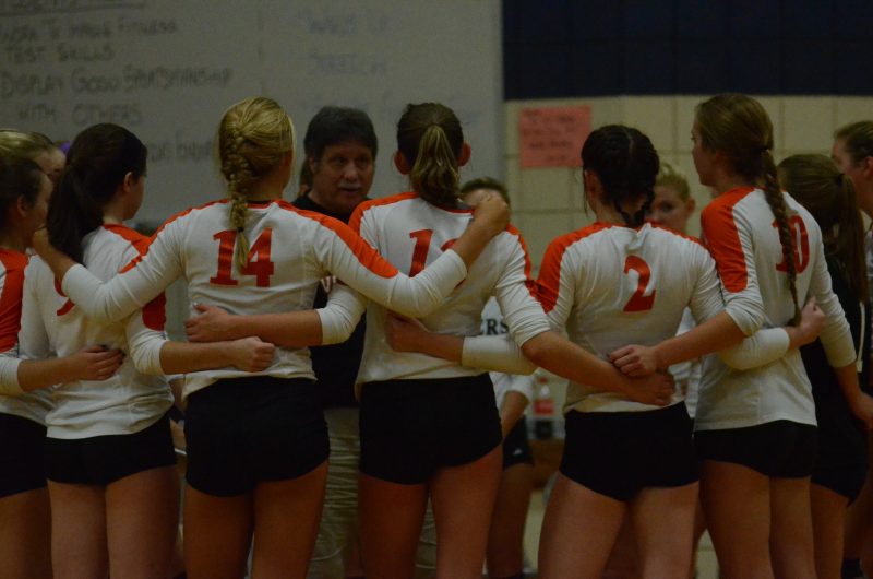 The Warsaw volleyball team listens to instructions from coach Rick Ashmore.