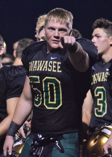 Jeremiah Dilley finds the camera as the Warriors stopped to sing their fight song following Friday's 48-7 win over West Noble. (Photos by Nick Goralczyk)