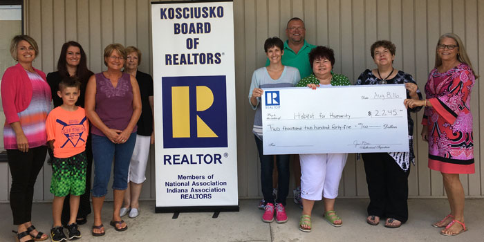 From left are KBOR PR committee members Shelley Dobbins, Leanne Francis, son Caden Francis, Lori Rockwell and Jan Miller; Habitat family Gina and Lee Ratliff; KBOR PR committee members Marcia Anderson and Nanette DeGaetano; and Habit for Humanity President Diana Creech. (Photo provided)