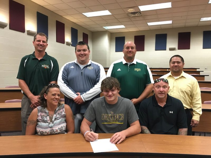 Wawasee's Austin Pearish signed to play football at Defiance College Thursday. Pictured in front, from left, are Samantha Pearish, Austin Pearish and Ken Pearish. In the back is vice principal Vince Beasley, assistant football coach Adolph Hathaway, head coach Josh Ekovich and principal Kim Nguyen. 