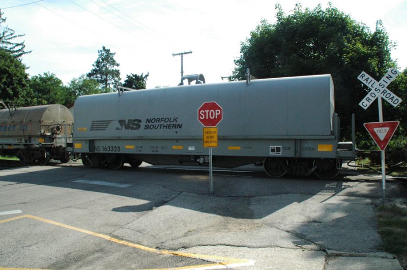 BLIND CROSSING — This unguarded railroad crossing on Emeline Street in Milford is one Norfolk Southern Railroad would like to close. The company has offered just under $20,000 to the town if it does so. The cost of constructing guard rails is said to be around $300,000. (Photo by David Hazledine)