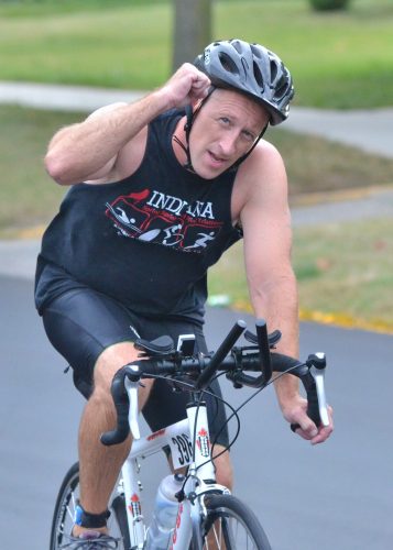 Tony Klepinger shows the camera some love during the biking portion of Saturday's Wawasee Tri. (Photos by Nick Goralczyk)