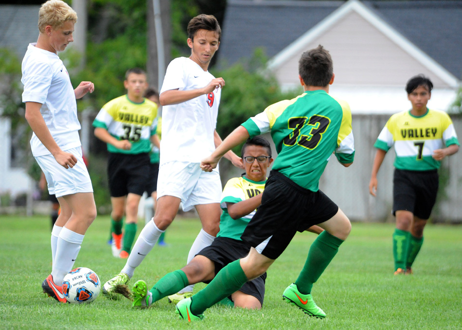 Tippecanoe Valley's Diego Hernandez slides in to disrupt NorthWood's Dylan Weldy Thursday in the boys soccer opener for both schools. (Photos by Mike Deak)