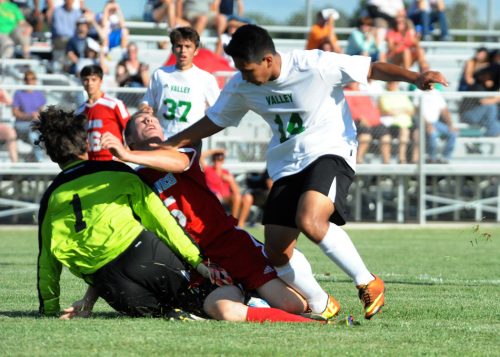 Tippecanoe Valley's Ivan Santiago collides with Maconaquah defender Austin Adair and goalkeeper Luke Edgington.