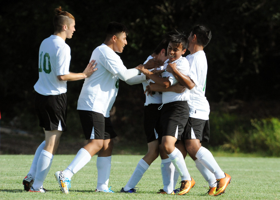 Tippecanoe Valley's Manny Dominguez is swarmed by teammates after scoring the first goal in school history Monday afternoon against Maconaquah. The Braves rallied to beat the Vikings, 4-3, in boys soccer. (Photos by Mike Deak)