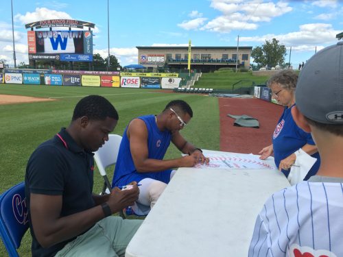 Jose Paulino, near, signs autographs for fans Sunday, Aug. 7. Paulino was named the July Pitcher of the Month, and sits with Cubs' May Player of the Month Eloy Jimenez.