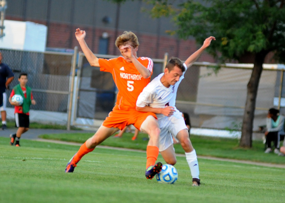 Fort Wayne Northrop's Will Allison (5) and Warsaw's Cole Voss mix it up during the 2-2 draw Tuesday night at Warsaw. (Photos by Mike Deak)