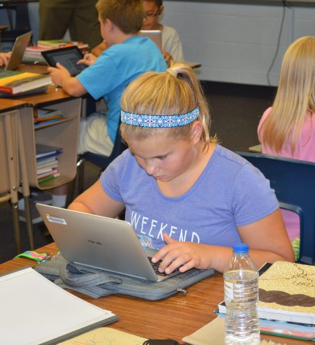 Fifth-grader Morgan Anderson uses her Chromebook while working on a math problem in Roger Brady’s classroom at Syracuse Elementary.