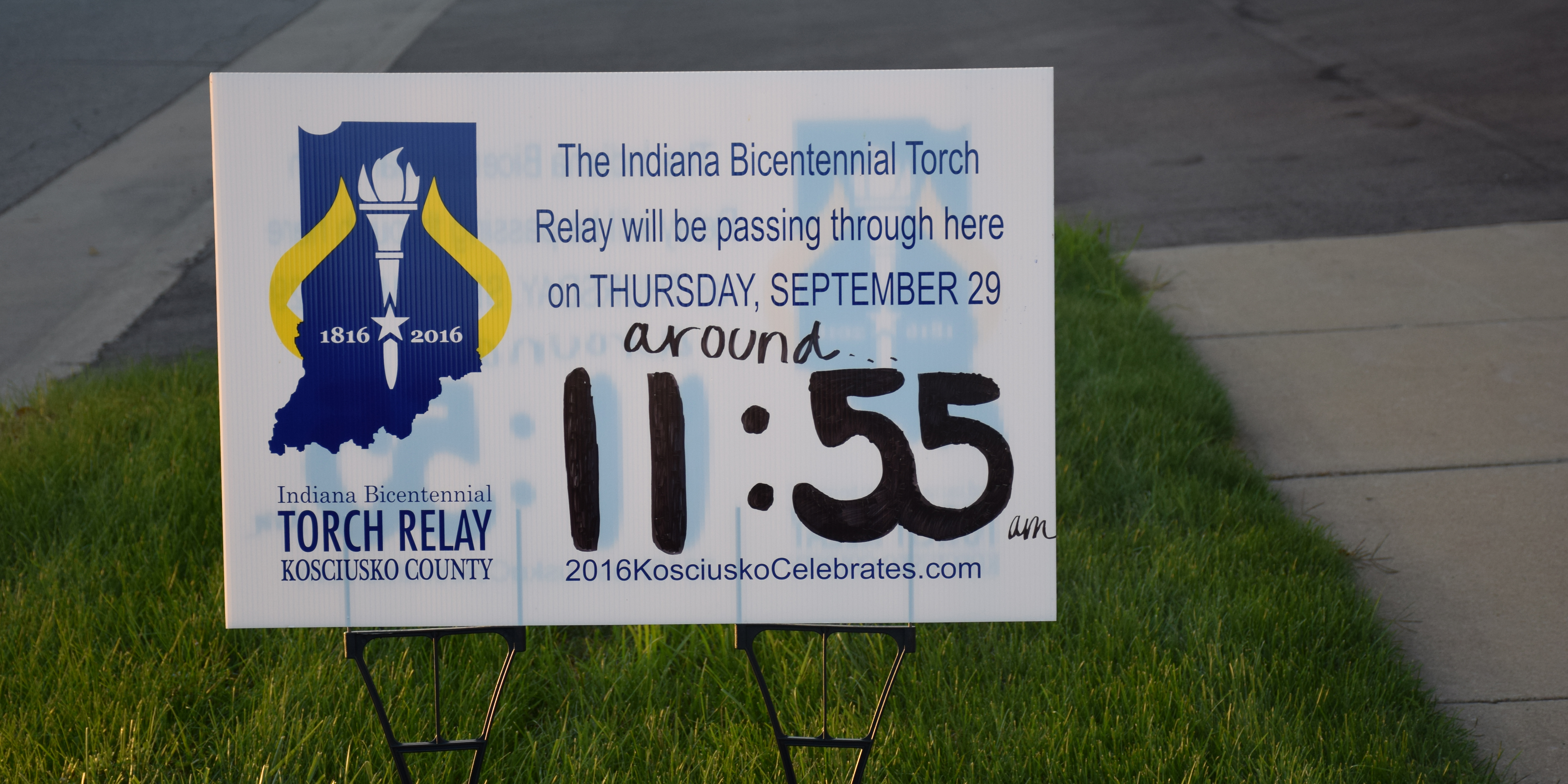 One of the signs set up along the route that features the approximate time the torch will pass through. 