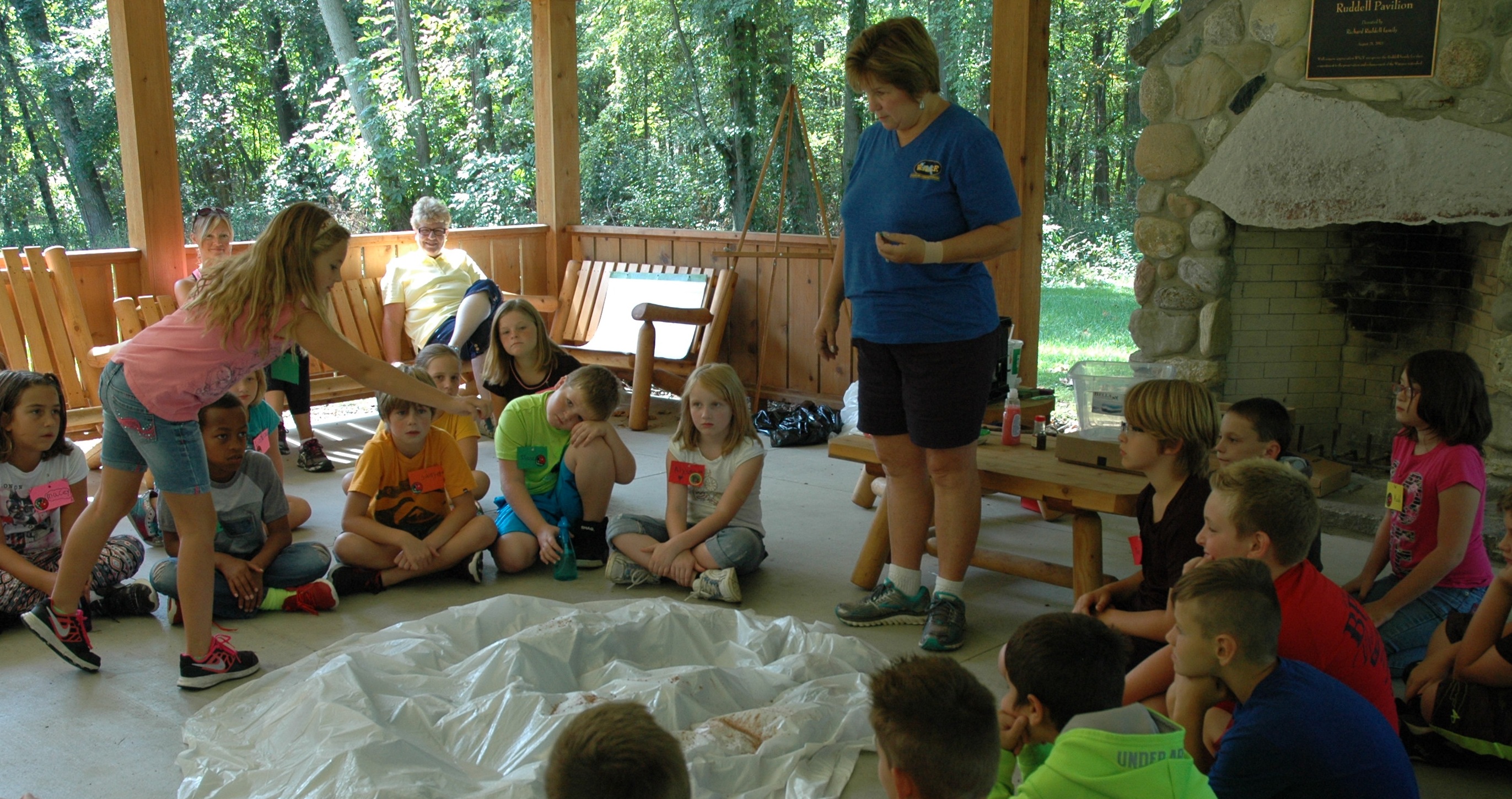 Pam Schumm allows the North Webster Elementary School fourth-graders to add pollutants to the watershed.