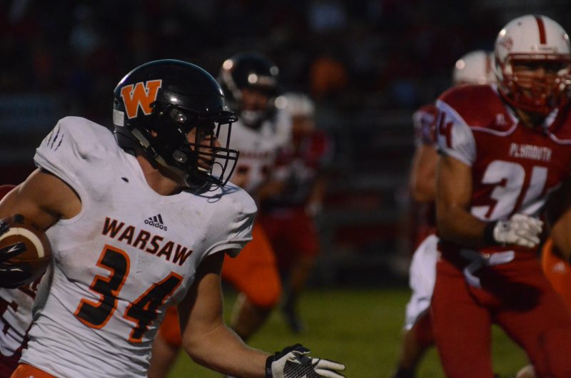 Will McGarvey rambles for a gain for Warsaw Friday night during a 17-10 NLC loss at Plymouth.