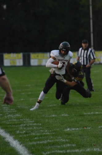 Zach Riley returns a punt for Warsaw.