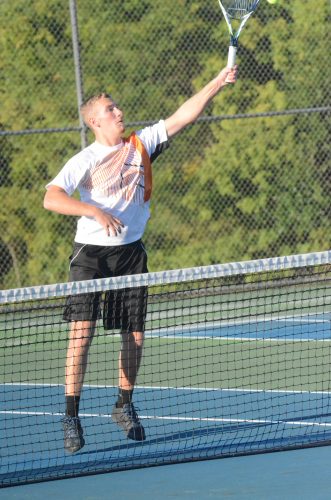 Warsaw's Hayden Steger reaches for a shot at the net at Concord Monday night. 