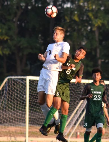 Grace College's Mitchell Zeilenga going up for a header against Roosevelt on Monday. (Photo by Chantel Shetler)