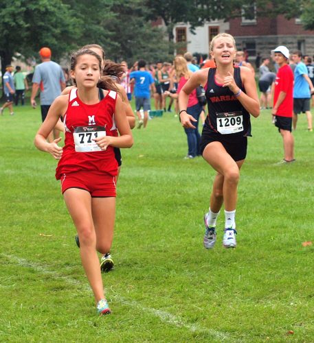 Mia Beckham (right) was the top finisher for the No. 4 ranked Warsaw girls team.