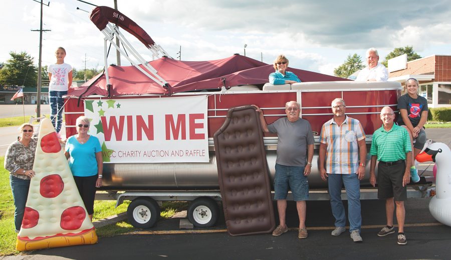 The pontoon is just one of the four grand prizes to choose from for the winner of the North Webster Community Center Heart of the Community Auction & Raffle. Some tickets are still on sale. In front, from left, Director of Operations Erin Smith, NWCC board members Janet Miller, Jon Sroufe, Todd Oesch and Dennis Wagoner. In back are Ali Smith, board members Lori Mark and Greg Schenkel and Abi Smith. The float props are courtesy of North Webster Ace Hardware.