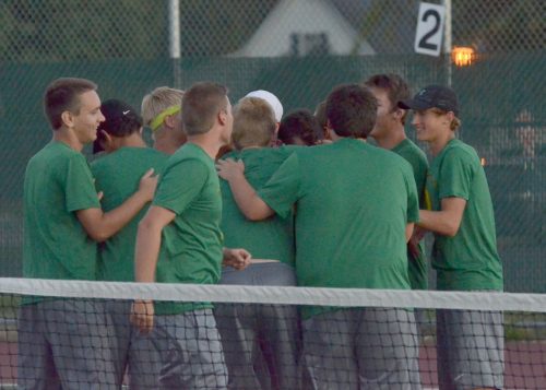 The Wawasee boys tennis team mob Dylan Staley after he clinched the team's first conference win of the season. (Photos by Nick Goralczyk)