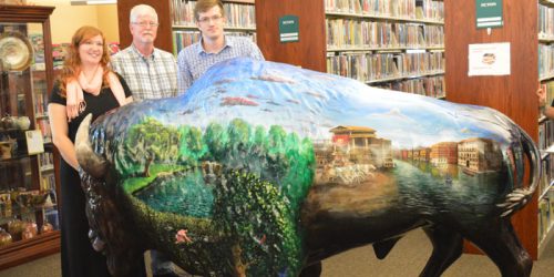 Shown are artists Kasha Iacob, Kerry Barrett and Trent Barrett with Wooly Webster, the new Bison at the North Webster Community Public Library. Wooly was unveiled at the start of the annual cemetery walk, held Sunday, Sept. 11