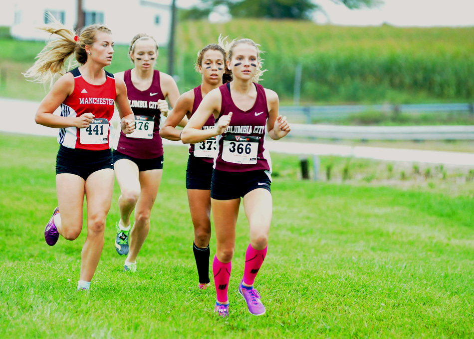 Columbia City's Bailie Brown leads the pack, with teammates Jasmine Early and Lillie Oddou along with Manchester's Rae Bedke during action at the Tippecanoe Valley Cross Country Invitational Saturday morning. (Photos by Mike Deak)