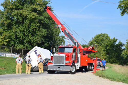 Crews work to move the truck out of the roadway.