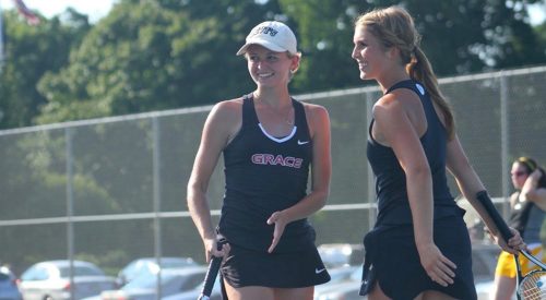 Grace College's Mariah Lewis and Gabrielle Lawrence smile during their 8-1 win at No. 3 doubles against Manchester on Monday. (Photo provided by the Grace College Sports Information Department)