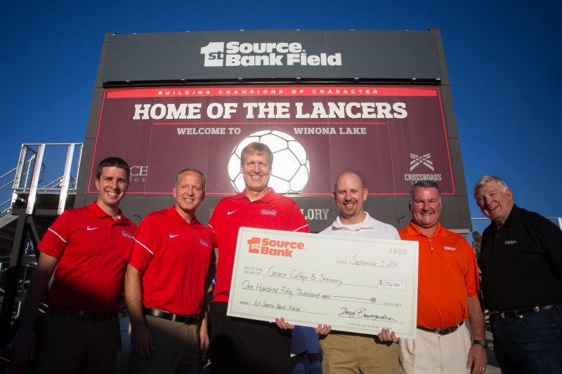The Grace College soccer facility was renamed the 1st Source Bank Field Saturday. Pictured above (from left) are Drew Flamm, Chad Briscoe and Jim Swanson of Grace College, along with Doug Baumgardner, Bill Burton and John Elliott of 1st Source Bank (Photo provided)