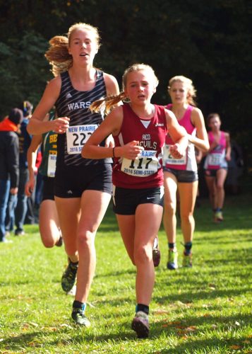 Warsaw's Allison Miller (222) works her way around Lowell's Brooke Hayden (117) as runners emerge from a woods at the 3,000-meter point of the girls semistate cross country race Saturday at New Prairie.