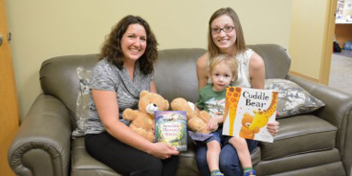 Pictured from left are Beaman Home Executive Director, Tracie Hodson accepting the donation from Jamie Rensberger, UsBorne Books & More Independent Consultant, and her son, Gideon Rensberger.