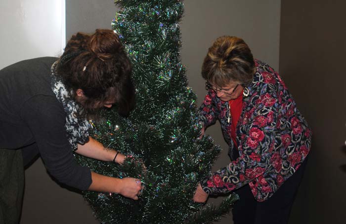 Lindsay Rex and Karen Murphy decorating the Adopt-A-Family tree.