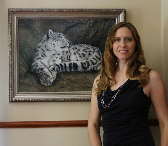 Jennifer Caudill stands next to one of her Ecuadorian subjects, a snow leopard. 