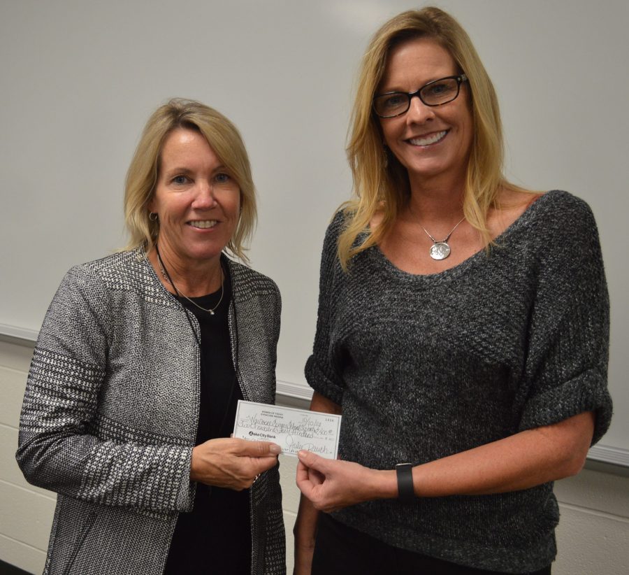 Holly Tuttle, left, representing Women of Today, presented a check in the amount of $2,400 during Tuesday’s school board meeting to be used as needed by the Wawasee Community School Corp. Accepting the check is Rebecca Linnemeier, school board president.