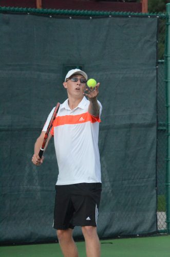 Colton Lind prepares to serve at No. 1 singles.