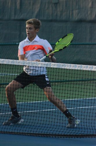 Spencer Britton is ready at the net in doubles action.