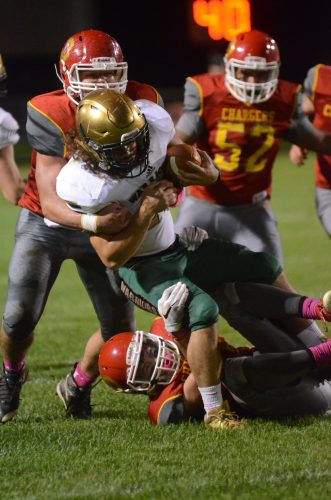 Noah Wadkins is bottled up by Memorial. Wadkins rushed for two touchdowns for Wawasee.