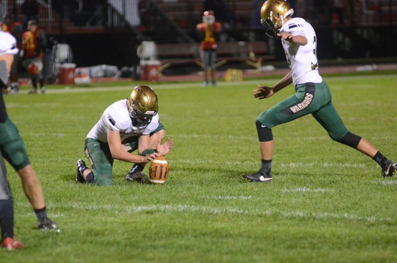Brayden Johnson prepares to boot a field goal for the Warriors.