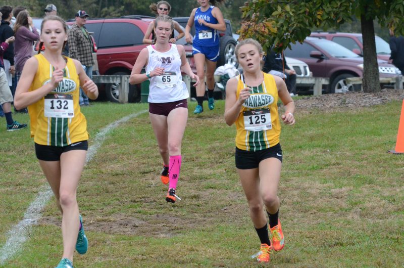 Bailey Schroeder (left) and Katie Haines run together for the Warriors.