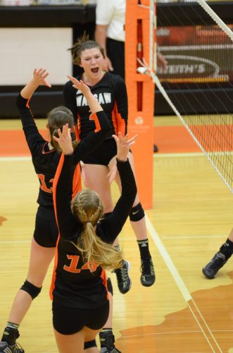 Nikki Parrett jumps for joy after a kill Thursday night. The Warsaw standout returned to action and helped the Tigers beat Elkhart Memorial 3-0 in the Warsaw Sectional.