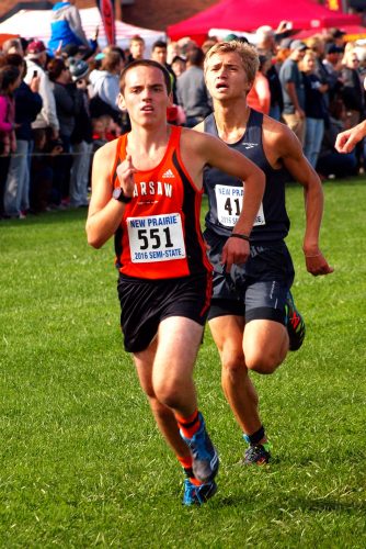 Warsaw's Lucas Howett (551) strains for the finish line at the end of his 5,000-meter race.