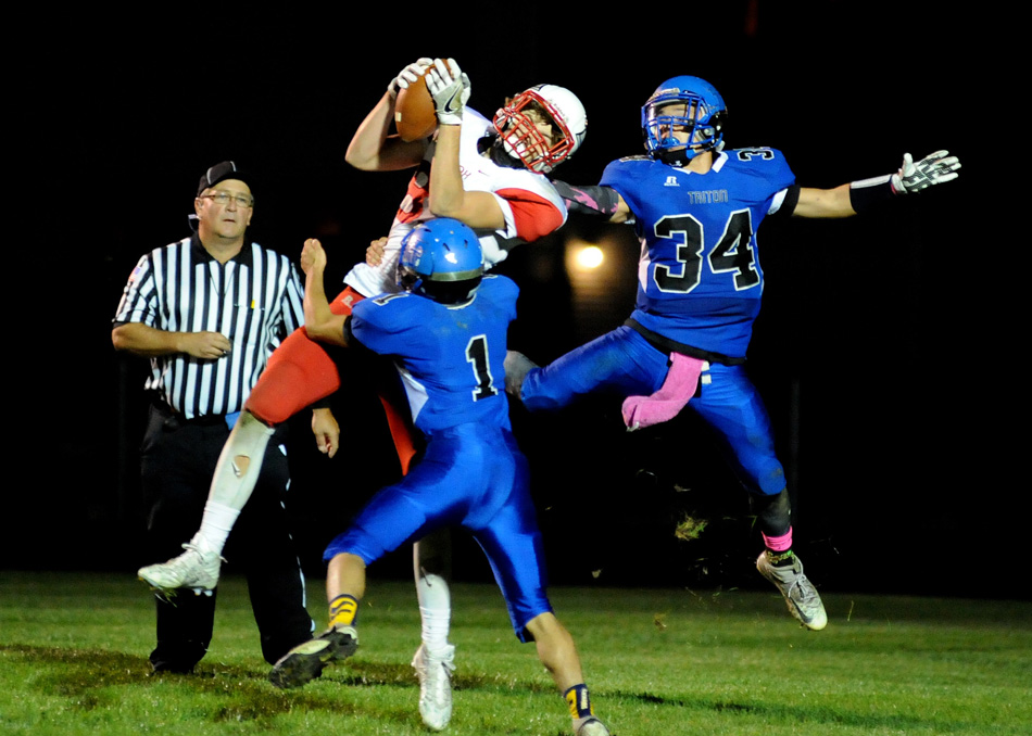 Knox's Austin Risner hauls in a touchdown catch during the Redskins' 34-33 win in triple overtime Friday night at Triton. (Photos by Mike Deak)