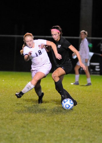 Warsaw's Breck Jackson and Penn's Alexis Marks aim for control of the loose ball.