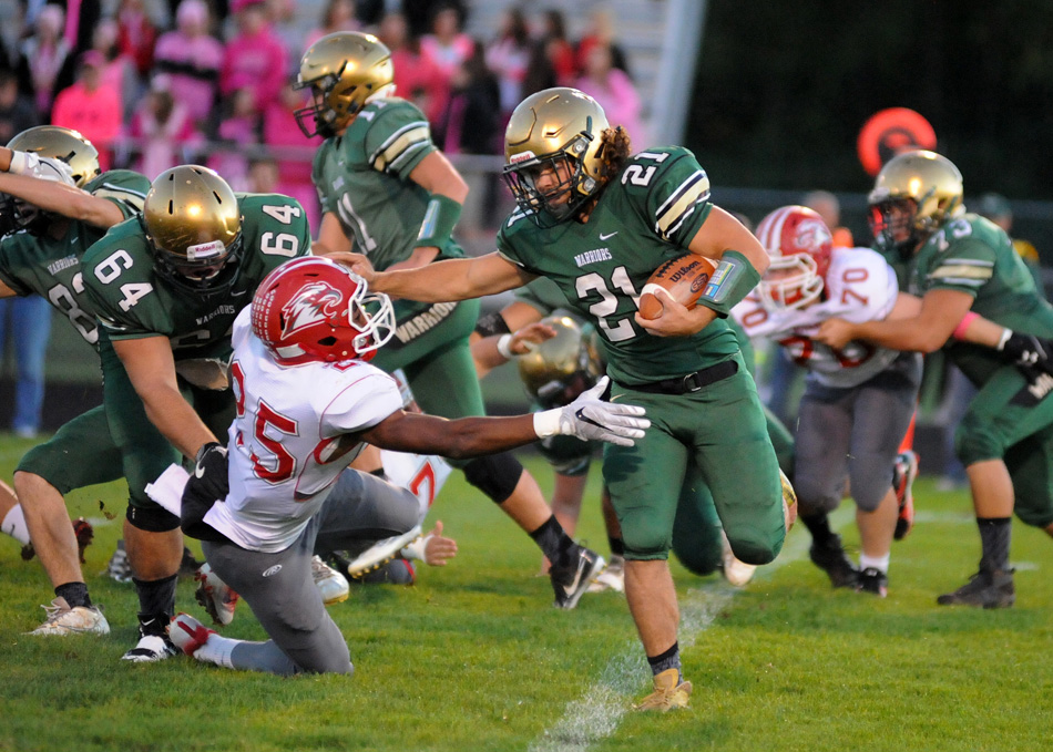 Wawasee's Noah Wadkins gets past the tackle attempt of Goshen's Rummel Johnson Friday night. (Photos by Mike Deak)