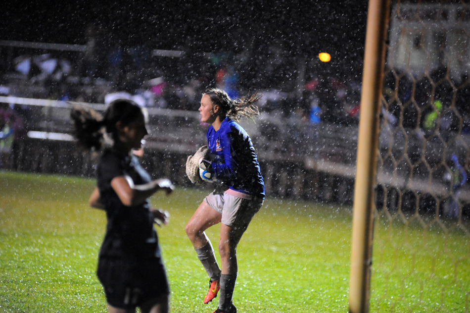 Warsaw goalkeeper Kaylee Patton hauls in a Penn shot attempt amidst a driving rain.