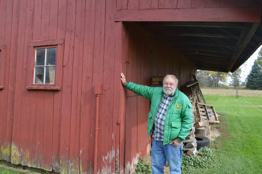 Mike Noel stands under the overhang of an English barn built in about 1900 on land he owns east of Leesburg. He still uses the barn for storage, but admitted he may decide someday to have the barn torn down.