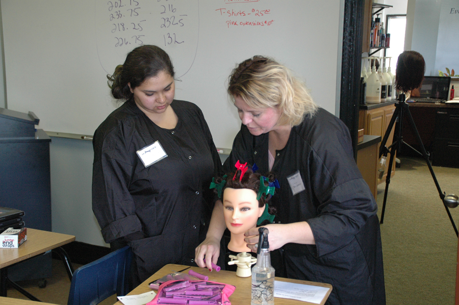 Inspire Cosmetology School owner/educator, Nicole Lawrence, right, worked with Joni Aguilar of Warsaw on a perm. “I see such potential in these students,” Lawrence exclaimed. (Photo by David Hazledine)