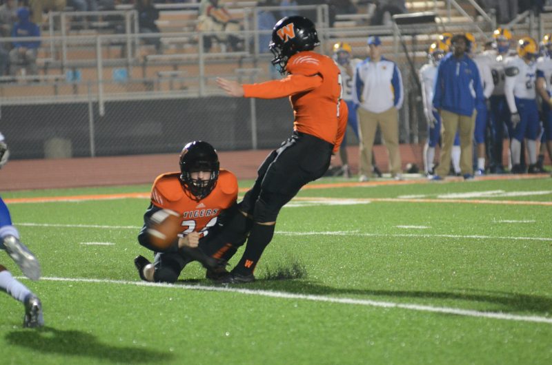 Warsaw All-American kicker Andrew Mevis drills a PAT out of the hold of Kyle Hatch Friday night. The Tigers lost 52-27 to No. 11 Homestead in a Class 6-A sectional final.