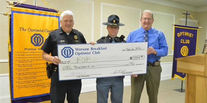 Pictured from left are Winona Lake Chief of Police Joe Hawn, and Trooper Chad James, representing the Fraternal Order of Police, and John Sullivan representing The Warsaw Breakfast Optimist Club. 