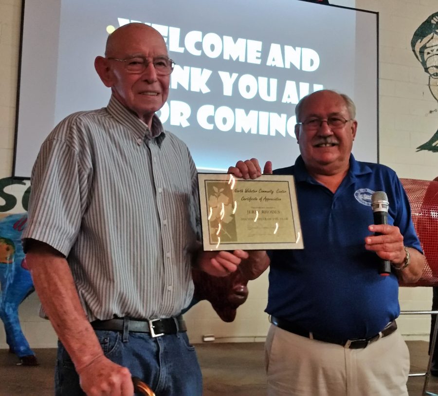 Jerry Rhodes, left, was chosen as the very first North Webster Community Center Volunteer of the Year. Jon Sroufe presented the award at the auction.